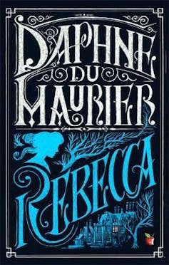 Book cover: blue and white lettering reads Daphne du Maurier, Rebecca