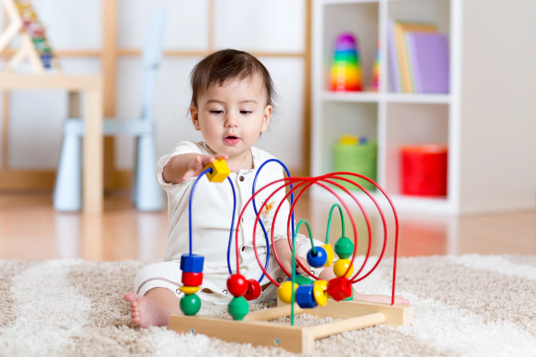 A baby plays with a toy.
