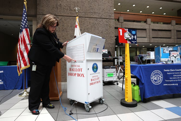 Santa Clara County Registrar of Voters' Shannon Bushey shows an official county ballot collection box