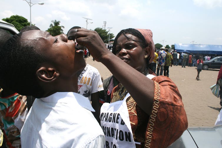 A person receiving oral polio vaccine in the DRC
