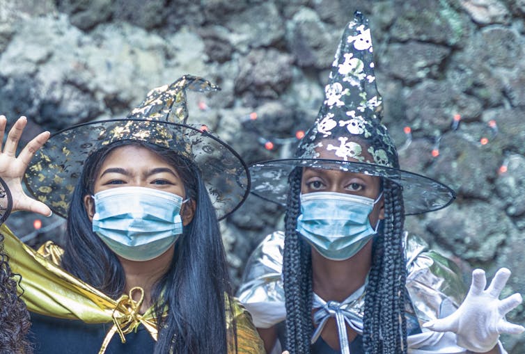 Two children dressed as witches.