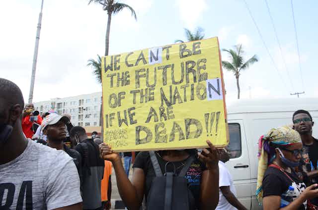 A protestor displays a placard at one of the EndSARS protests