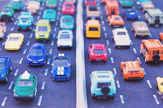 Model cars lined up bumper-to-bumper on a toy highway.