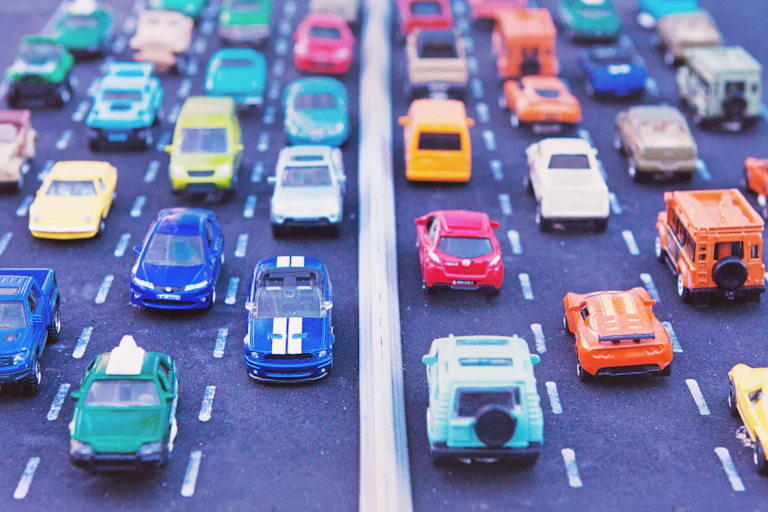 Model cars lined up bumper-to-bumper on a toy highway.