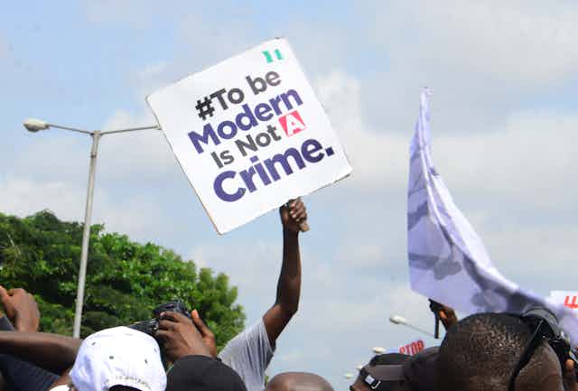 Youths of ENDSARS protesters display their placards in a crowd in support of the ongoing protest against the harassment, killings and brutality of The Nigerian Police Force Unit called Special Anti-Robbery Squad (SARS)