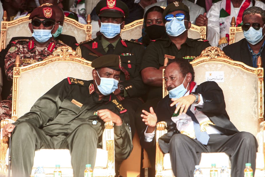 General Abdel Fattah al-Burhan (left) speaks with Prime Minister Abdalla  Hamdok (right) during an October 2020 ceremony celebrating the peace deal