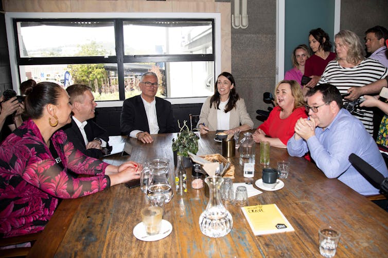 people sitting at a table with cups and glasses