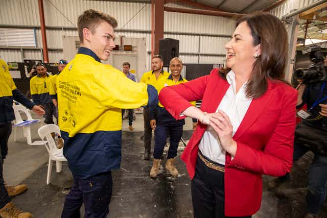 Queensland Premier Annastacia Palaszczuk elbow bumps with supporter