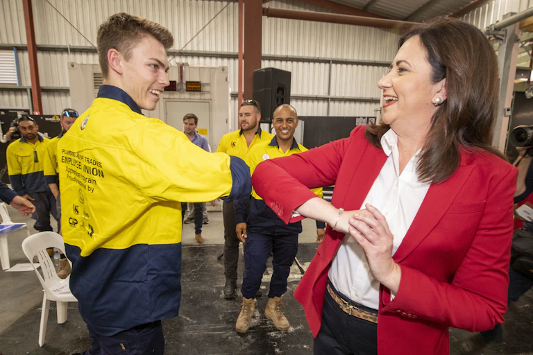 Queensland Premier Annastacia Palaszczuk elbow bumps with supporter