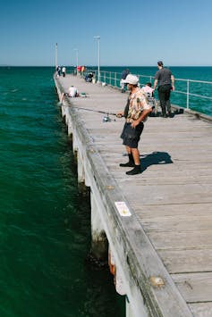 A man fishes in Melbourne.