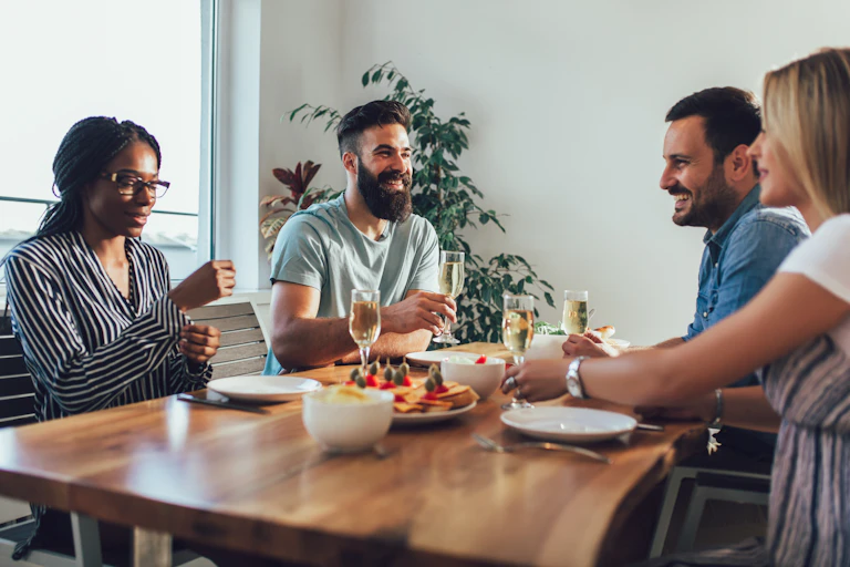 Four people gathering indoors