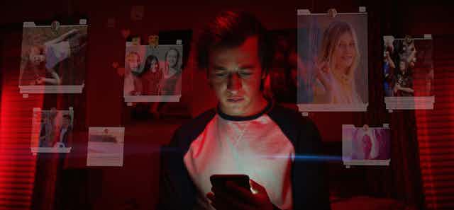 A young man looks at his mobile phone, the screen lighting his face. Around him are graphics showing photos from social media of beautiful young women and messages of fun and friendship.