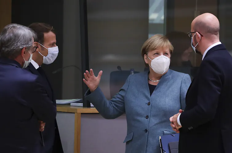 European leaders chat while wearing covid masks.