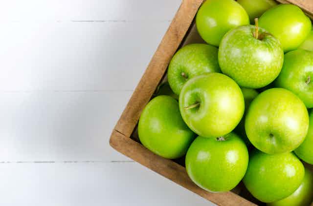 A box of green apples.