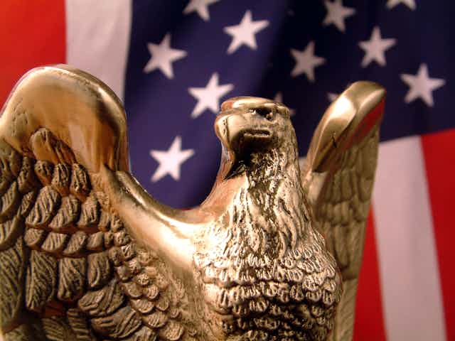 A bronze eagle and a U.S. flag