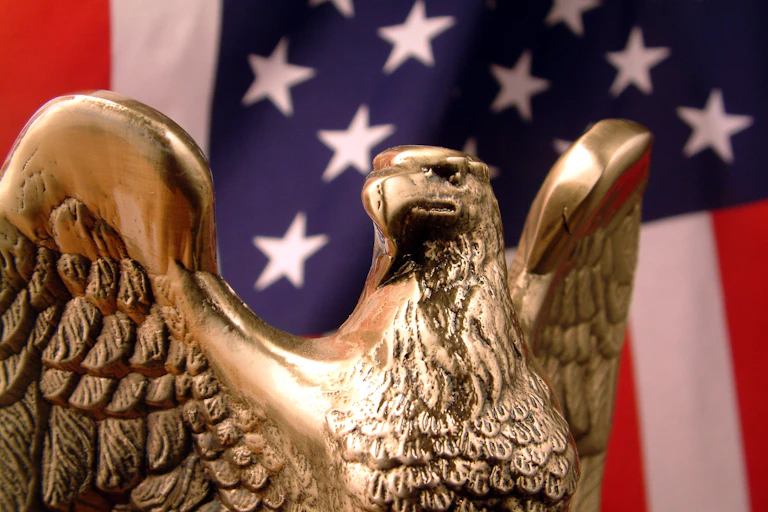 A bronze eagle and a U.S. flag