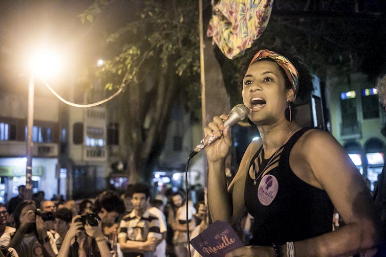 Franco speaks, animated, to a crowd