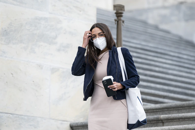 Alexandria Ocasio-Cortez walking down the stairs in the US Capitol.