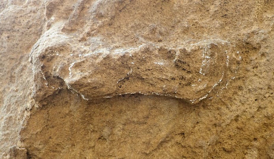 A slightly raised feature in a large rock, outlined in chalk to emphasise it