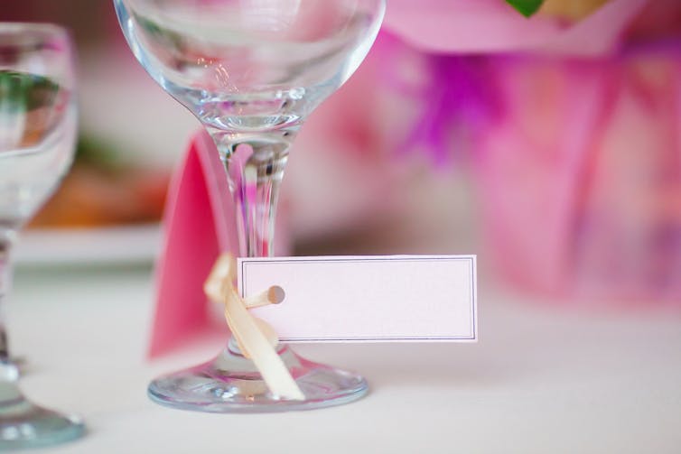 Wine glass with tag on the stem on a party table
