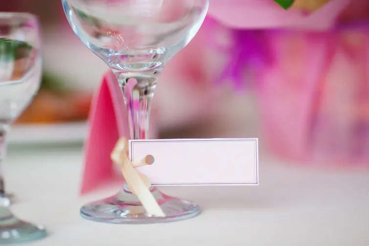Wine glass with tag on the stem on a party table