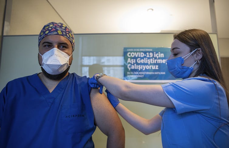 A health worker in Turkey administers a dose of Sinovac Biotech's COVID-19 vaccine.