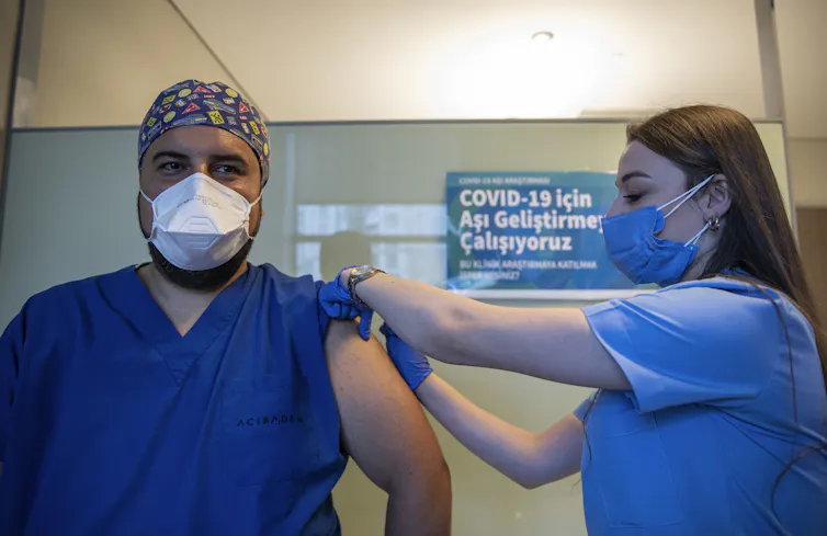 A health worker in Turkey administers a dose of Sinovac Biotech's COVID-19 vaccine.