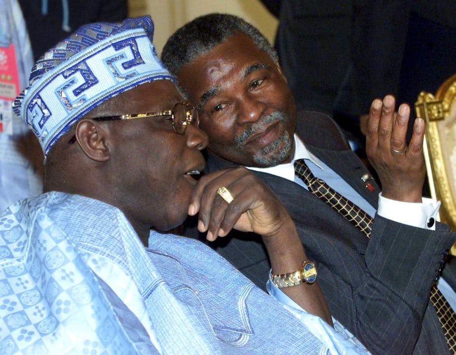 President Obasanjo, left, wearing a blue flowing Nigerian garb and matching hat, with Thabo Mbeki, wearing a dark grey suit and a black and gold check tie