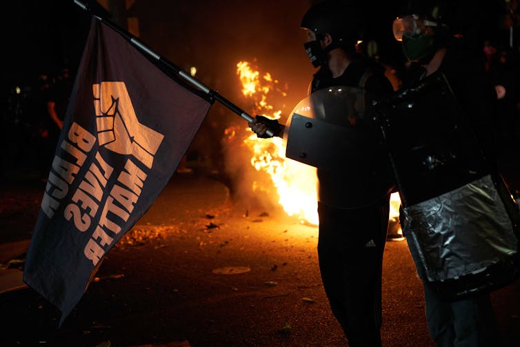 Black Lives Matter protesters near a fire in Portland, Oregon.