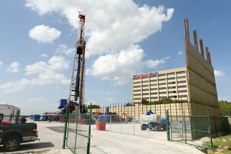 A drilling rig goes up near a bank building in Fort Worth, Texas.