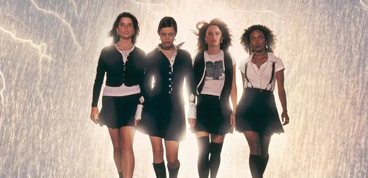 Four teen witches walking in a row.