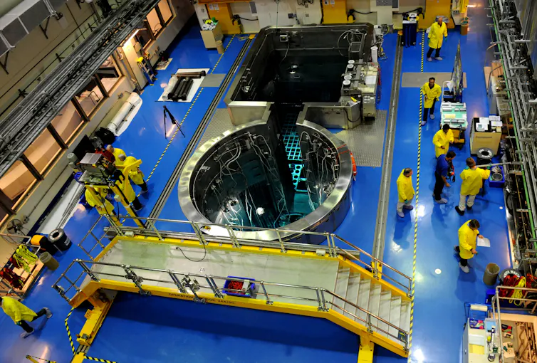 A nuclear reactor with people in protective gear around it