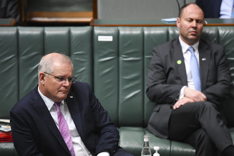 Scott Morrison, with Josh Frydenberg in the background