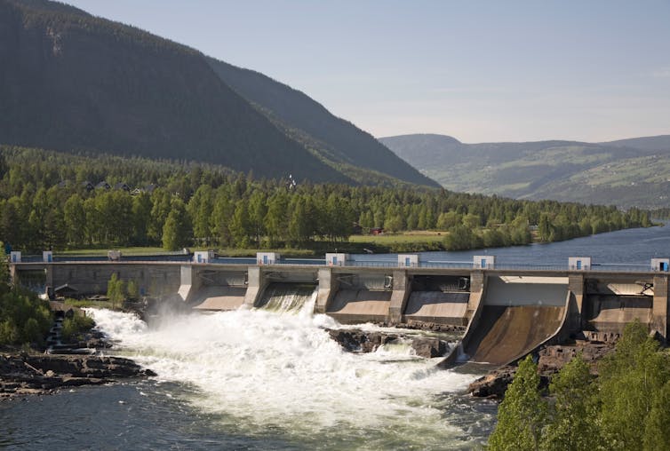 Dam and reservoir in a large forested valley