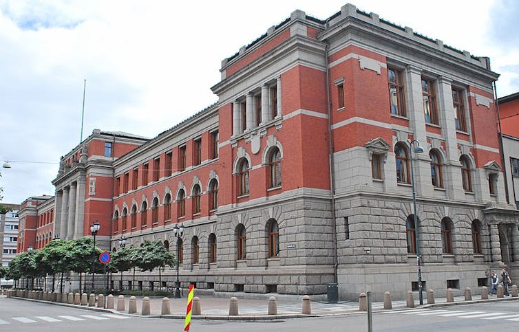 A large building made of stone and red brick.