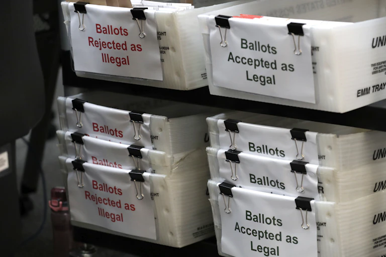 Florida ballots are placed in boxes labeled 'Rejected as Illegal' and 'Accepted as Legal'