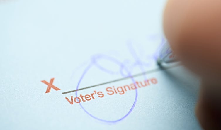 A person signs their name.