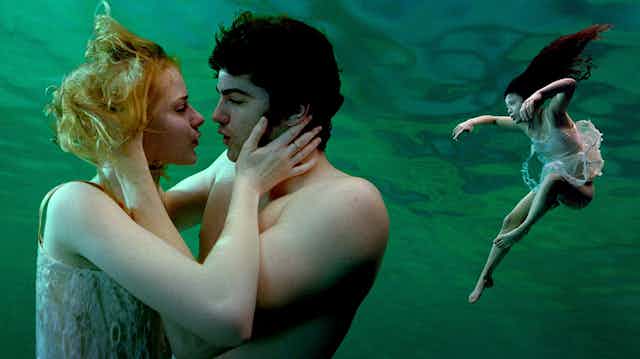 Movie still: two people kiss underwater