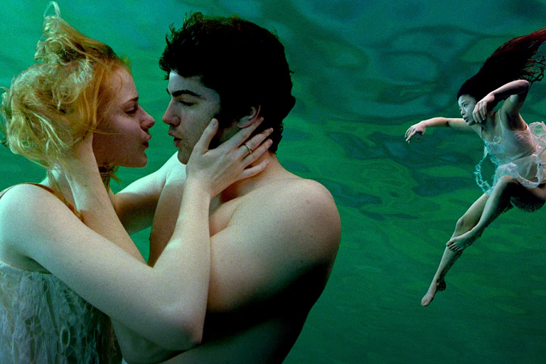 Movie still: two people kiss underwater