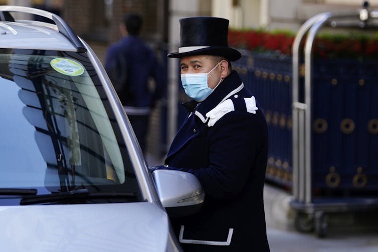 Hotel concierge talking to a taxi driver