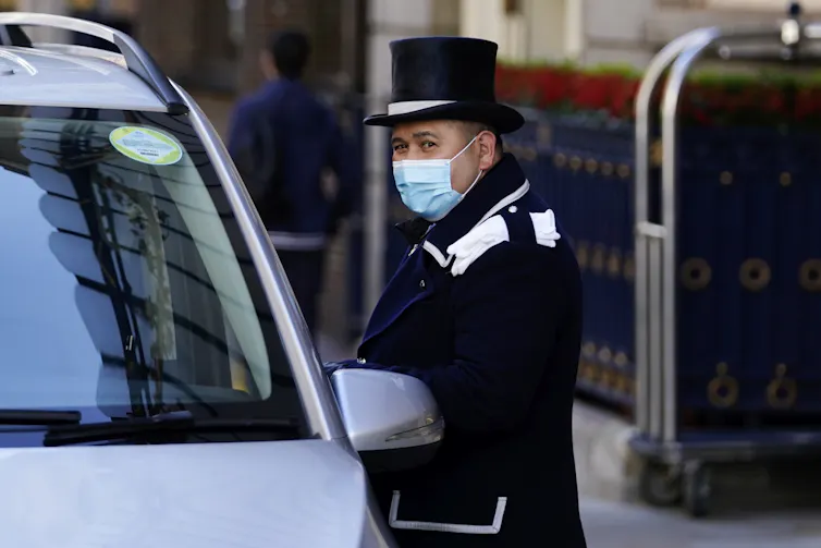 Hotel concierge talking to a taxi driver