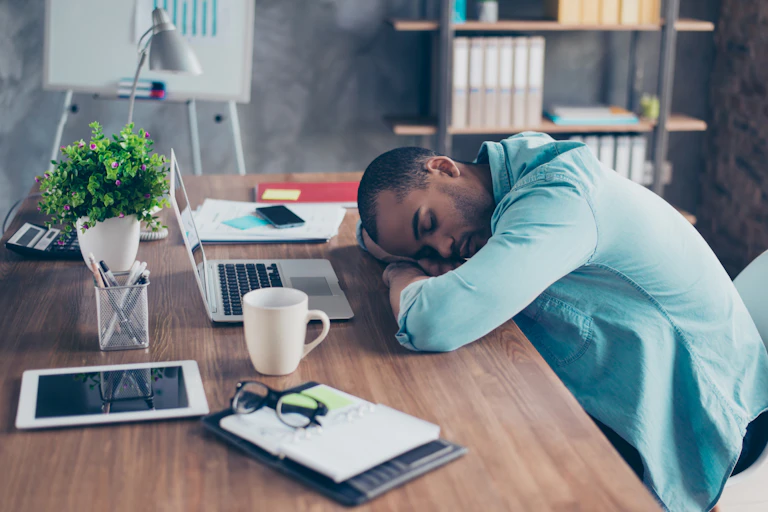 Tired man sleeping at his desk.
