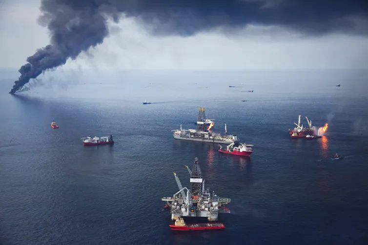 Large oil platform burning at sea.