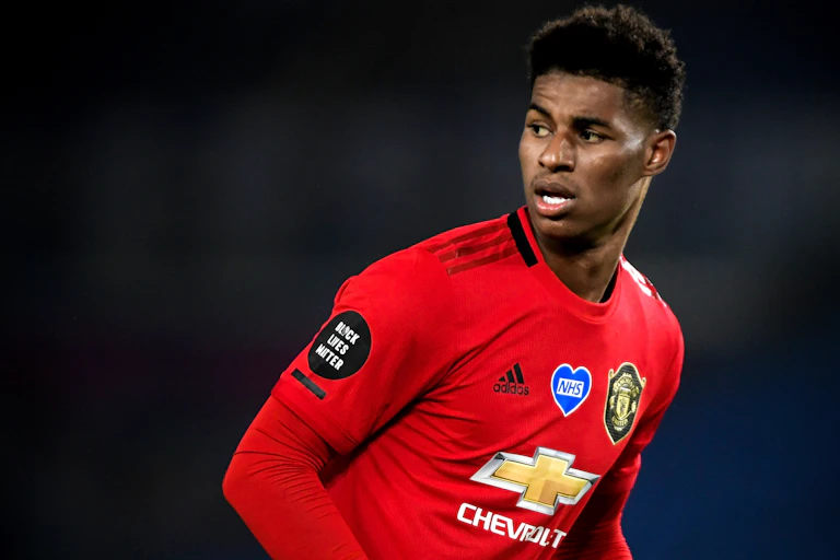 Photo of footballer Marcus Rashford, wearing red Manchester United kit.