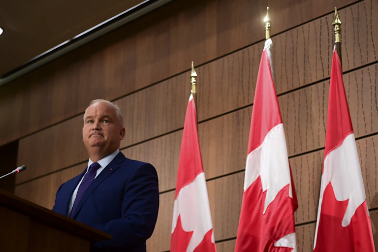 Erin O'Toole purses his lips at a news conference.