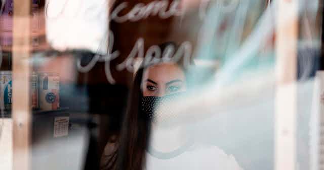 A cafe worker stands at window in Stillwater, Oklahoma.