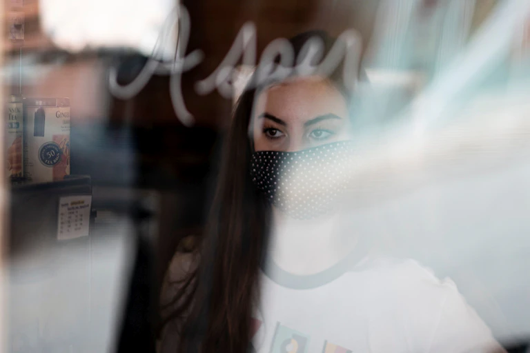 A cafe worker stands at window in Stillwater, Oklahoma.