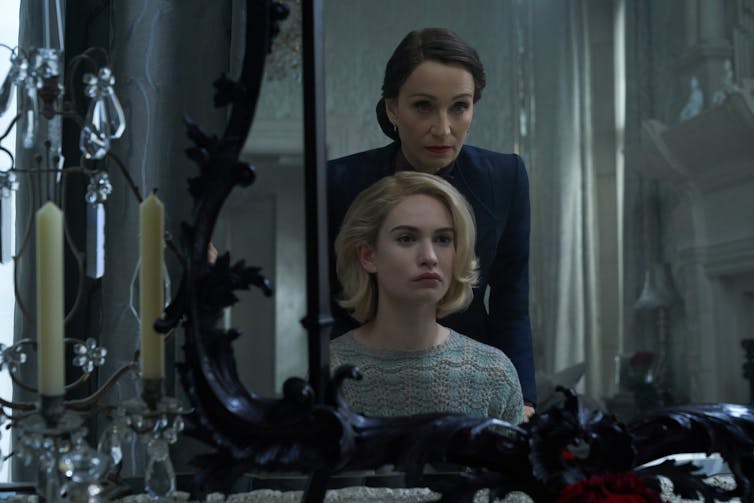 Two women seen in reflection in a mirror.
