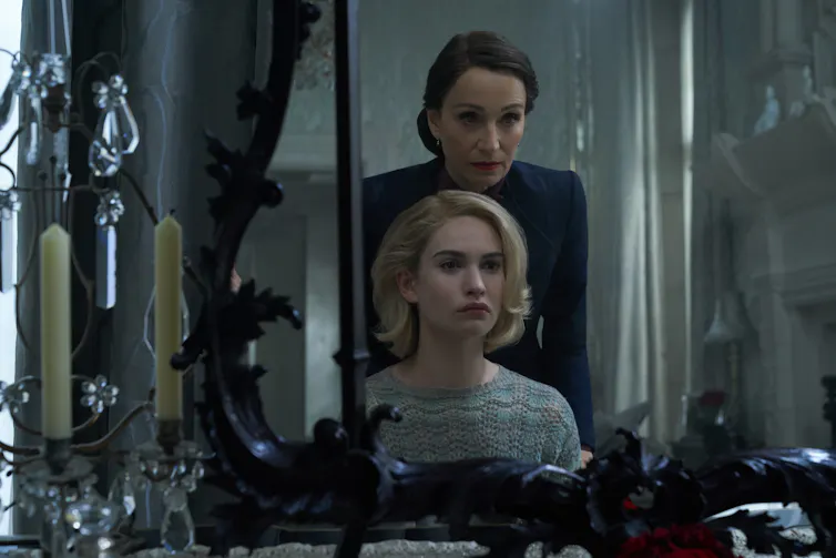 Two women seen in reflection in a mirror.