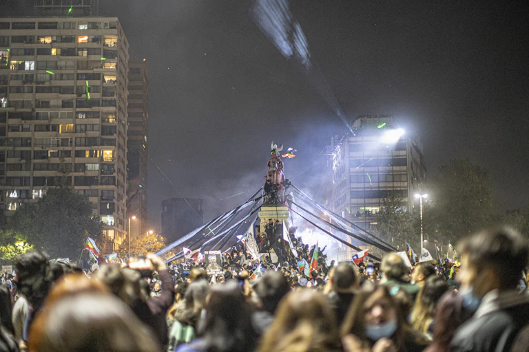 A crowd in a large public square at night